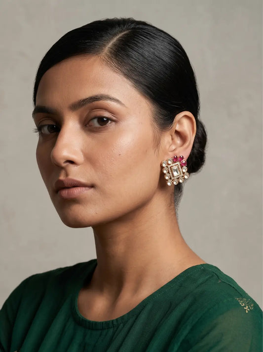 Ruby pink square polki stud earrings with kundan stones, coloured floral accents and gold plated detailing for wedding wear