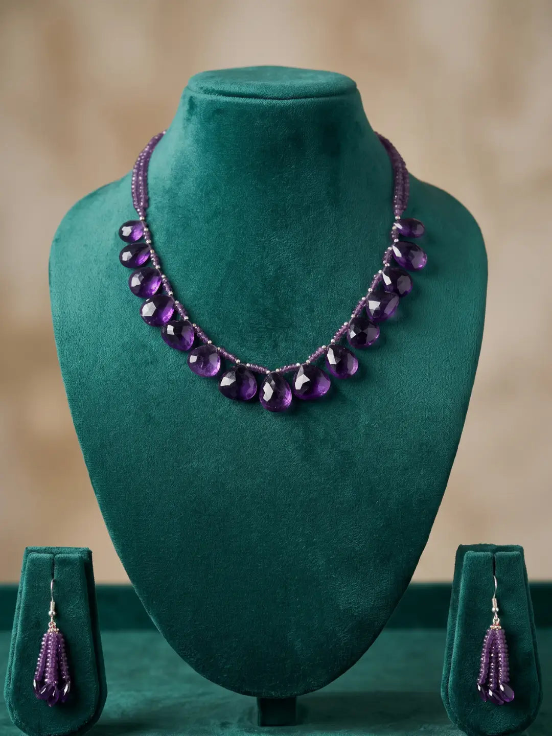 Matching multi-drop earrings in purple amethyst beads with silver-tone accents, designed to coordinate with the layered teardrop necklace