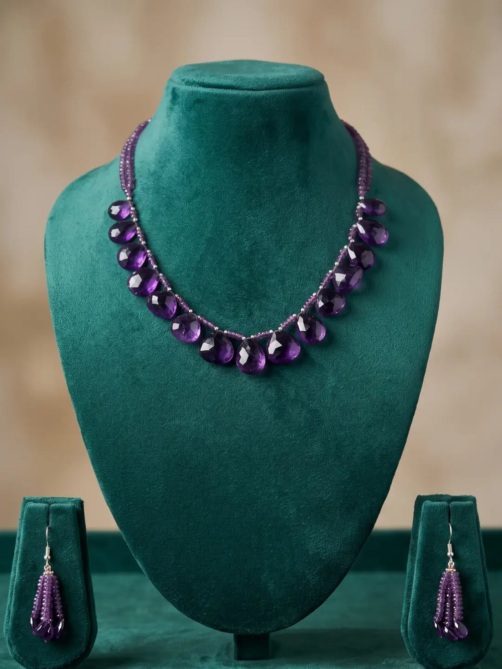 Matching multi-drop earrings in purple amethyst beads with silver-tone accents, designed to coordinate with the layered teardrop necklace
