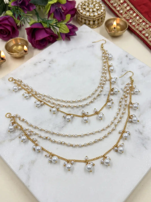Simple layered pearl ear chain with pearl clusters and gold-tone chain for bridal bun, Gajra and Indian wedding hairstyles.