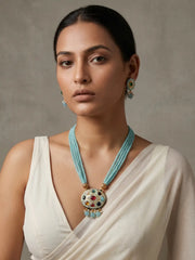 Gold-plated sky blue necklace featuring a Navratna Meenakari pendant, layered beads and matching stud earrings.
