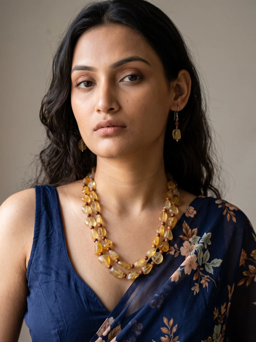 Second model view of a golden-yellow citrine and reddish-brown tiger eye beaded necklace with drop earrings, the two strands resting along the neckline