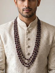 Three-layer groom mala featuring deep burgundy natural garnet beads, lustrous freshwater pearls and gold-plated detailing in a cascading design.