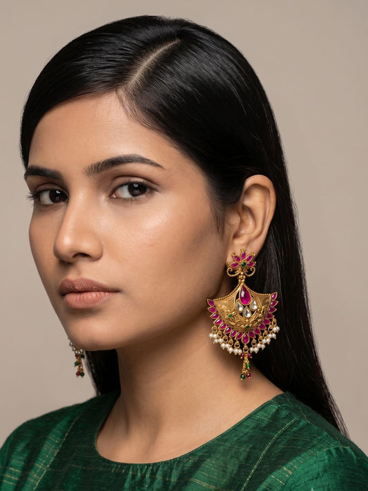 Traditional golden pink Chandbali earrings featuring Kundan stones, pink gemstone accents, pearl tassels and antique gold detailing for weddings.