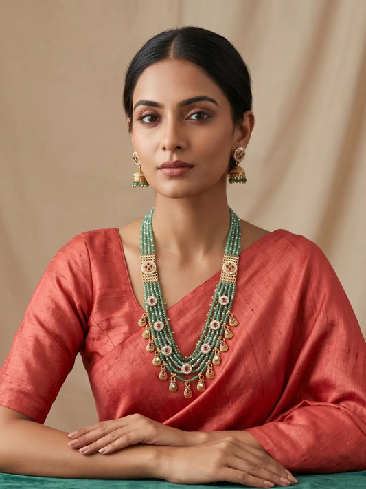 Traditional green beaded Kundan necklace featuring cascading jade bead strands, ruby-coloured motifs and gold-tone detailing for festive styling