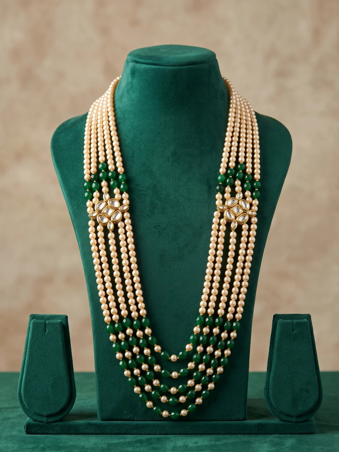 Green dulha mala for men with graduated bead layers, faux pearl strands and decorative Kundan-style side brooches in a traditional design.