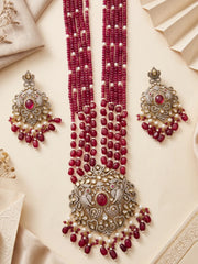 Long red jade bead necklace with pearl accents, ornate mehandi-plated pendant detailing and matching drop earrings for traditional Indian attire.