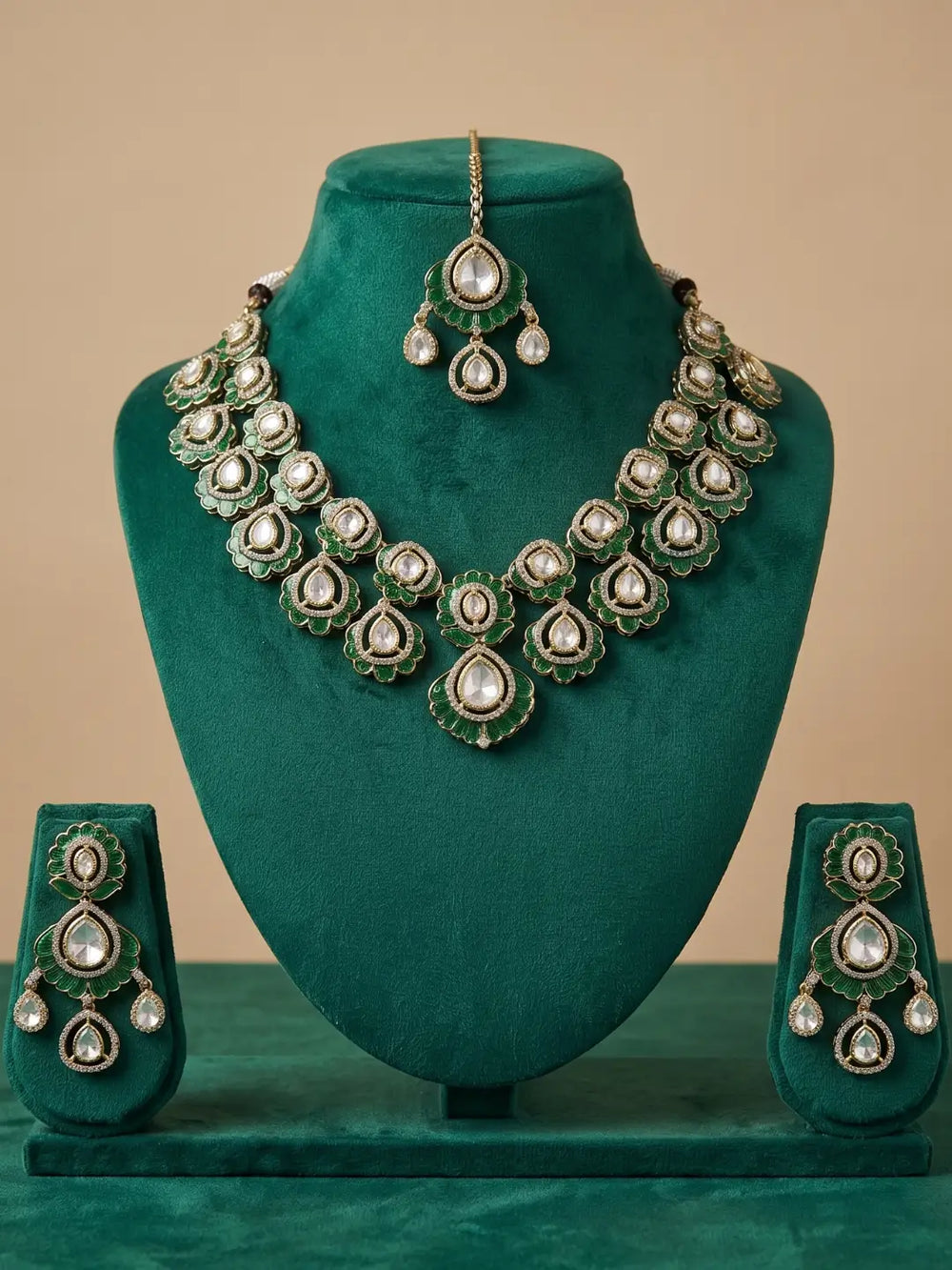 This traditional green necklace set includes matching earrings and a maang tikka, with Kundan, Polki, and CZ stones for wedding and festive outfits.
