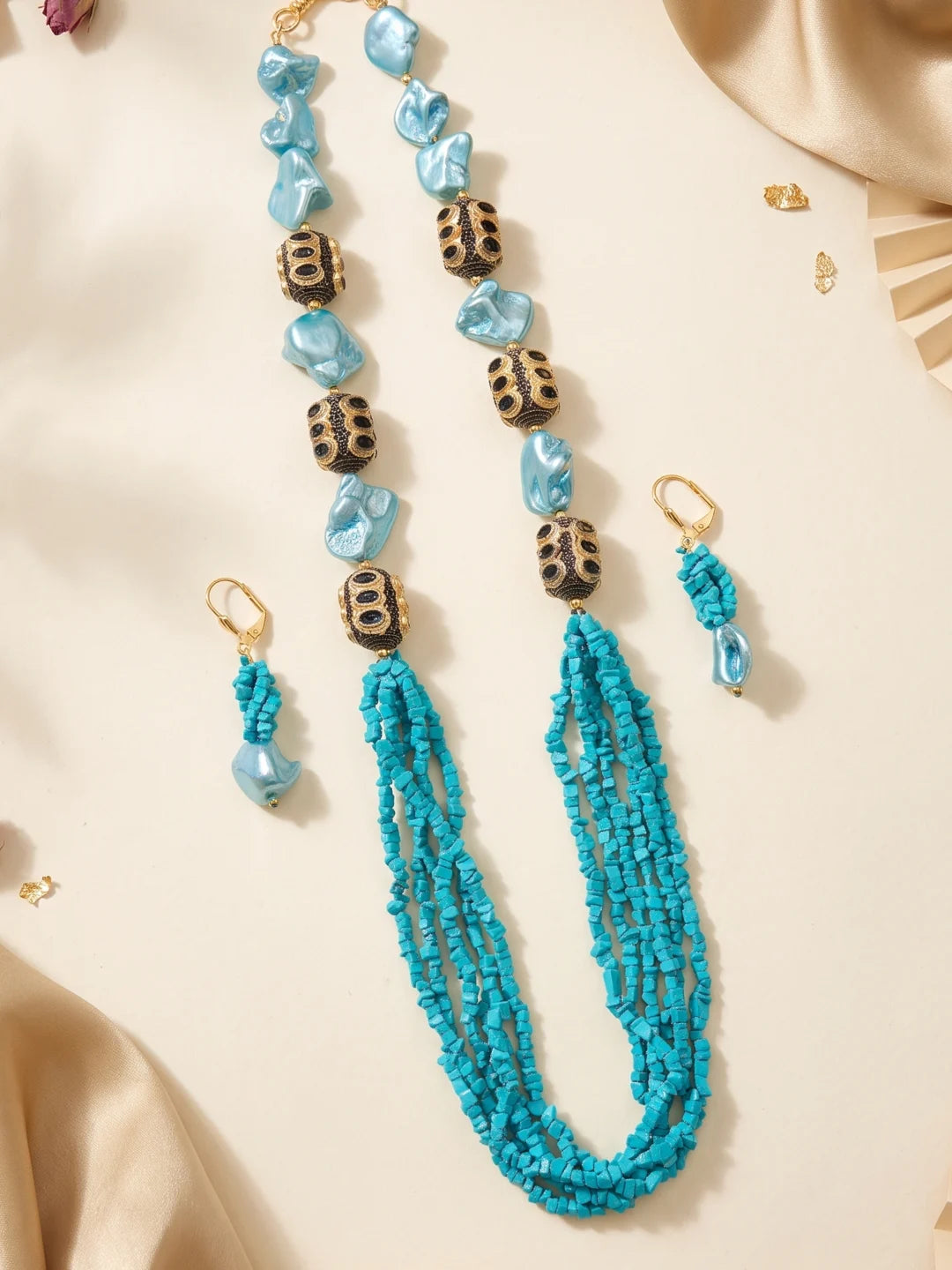 Pair of drop earrings with coordinated turquoise and blue beads, shown as the matching piece of the multi-strand necklace set