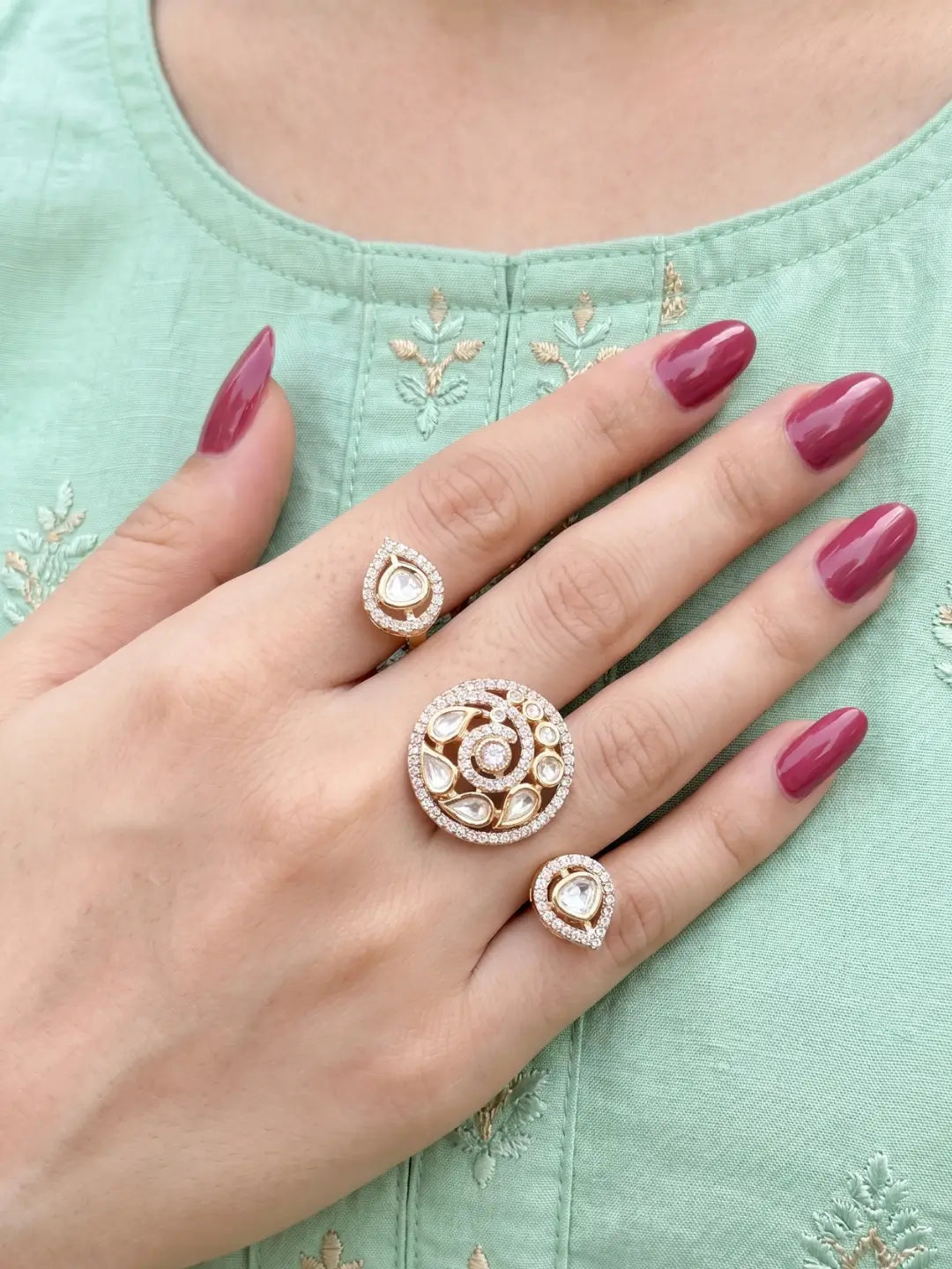 White Kundan Polki dual finger ring with two gold-tone bands, floral stone clusters and sparkling CZ details for bridal and traditional wedding looks