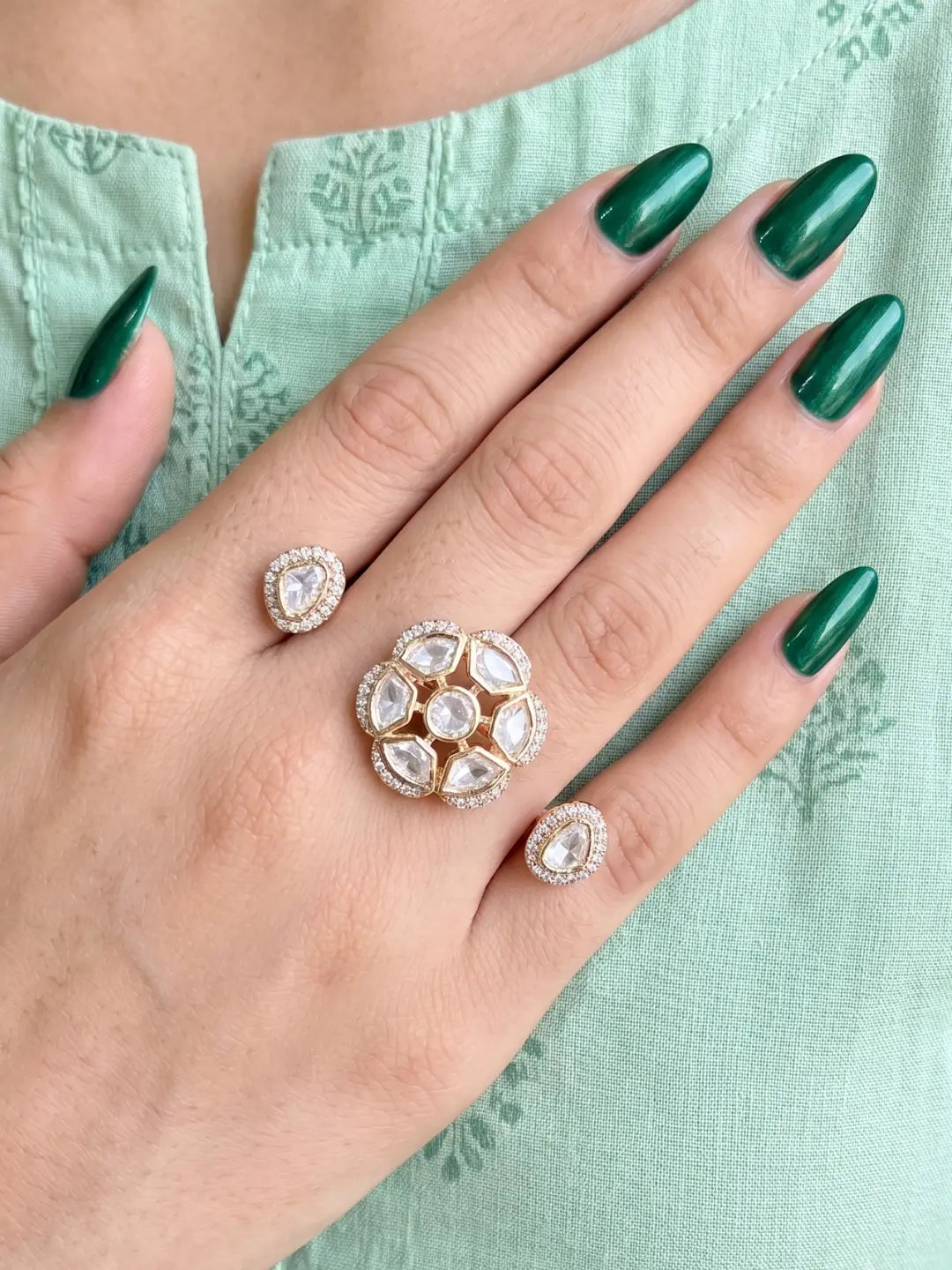 White Polki Kundan double finger ring with two connected gold-tone bands, floral stone clusters and sparkling CZ accents for bridal and festive styling