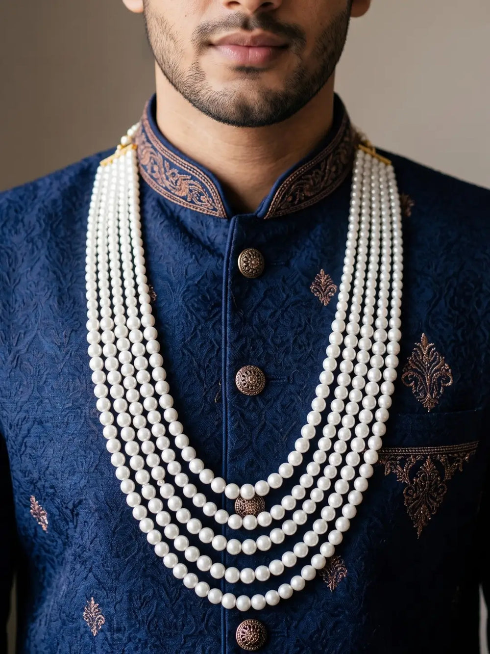 Men's sherwani mala with cascading rows of white AAA-quality shell pearls, creating a layered silhouette for traditional groom attire and ceremonies.