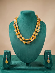 Double strand yellow citrine and tiger eye beaded necklace displayed on a neck mannequin, showing how the two strands fall around the neckline