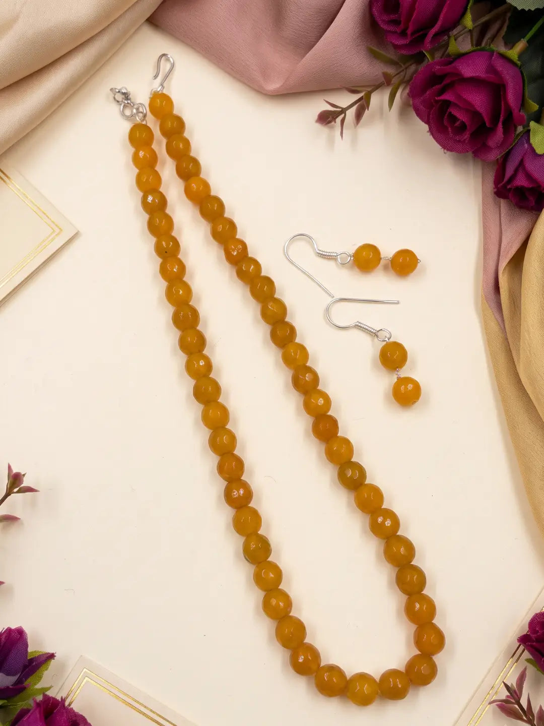 Single-strand yellow faceted round jade bead mala necklace shown with matching drop earrings and silver-tone accents