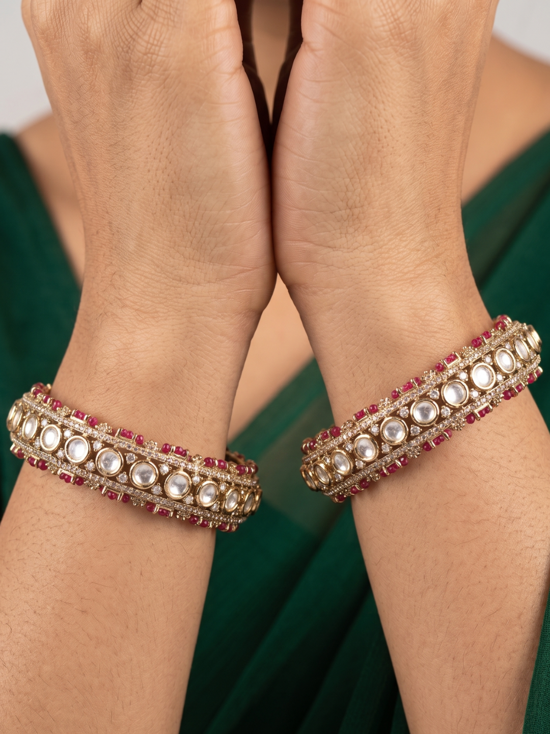 a close up image of a women hands wearing Designer Antique Victorian Polki Kundan Kada Bangles With Ruby Stones | Wedding & Bridal Bangles