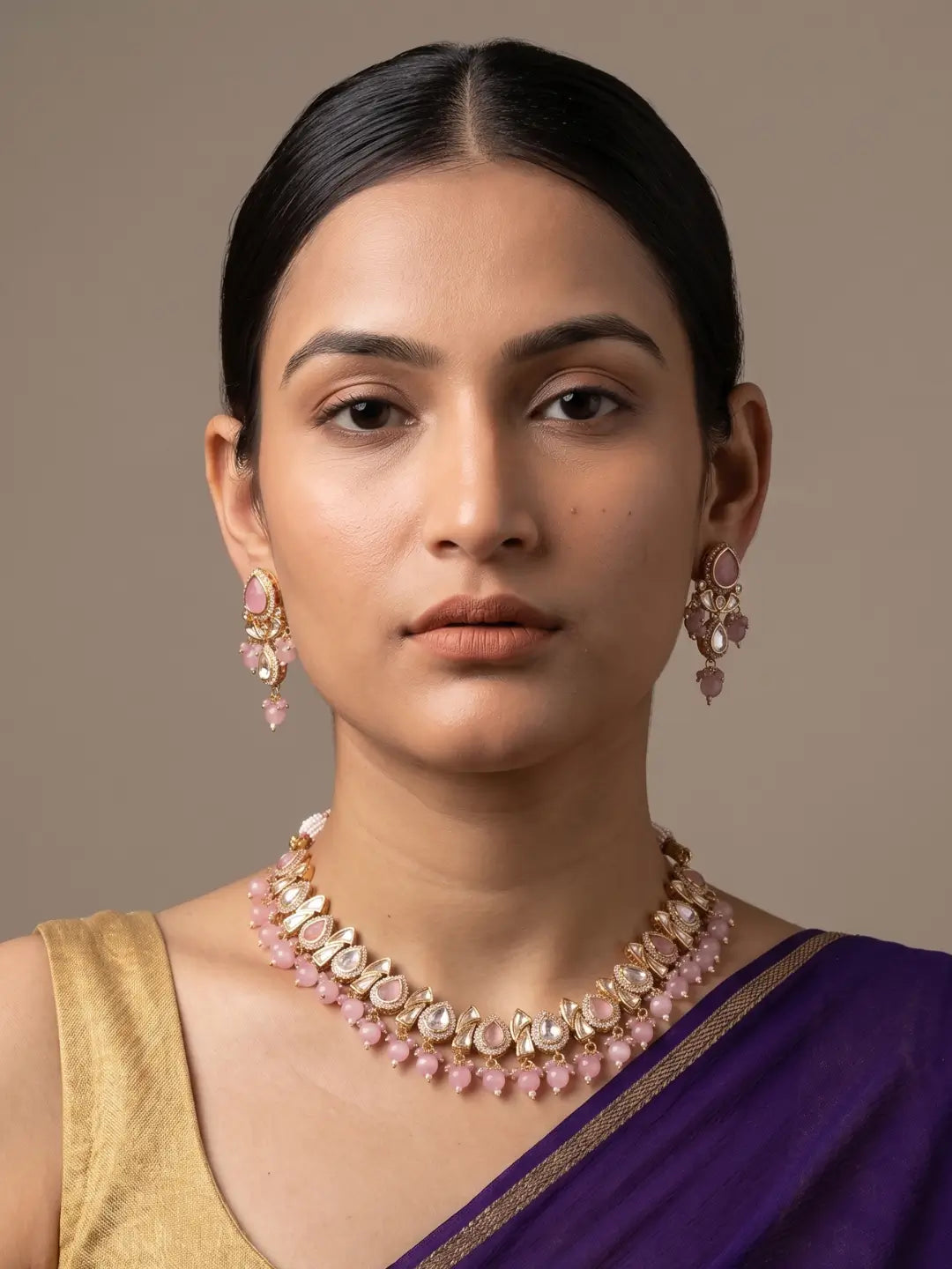 a women wearing and elegant Beaded Kundan necklace set featuring handcrafted baby pink And Kundan stones, delicate pearl drops, and matching earrings, perfect for bridal wear, weddings, festive occasions, and traditional Indian jewellery.