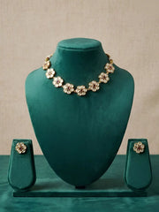 Polki necklace and earrings set on a green velvet mannequin against a beige background