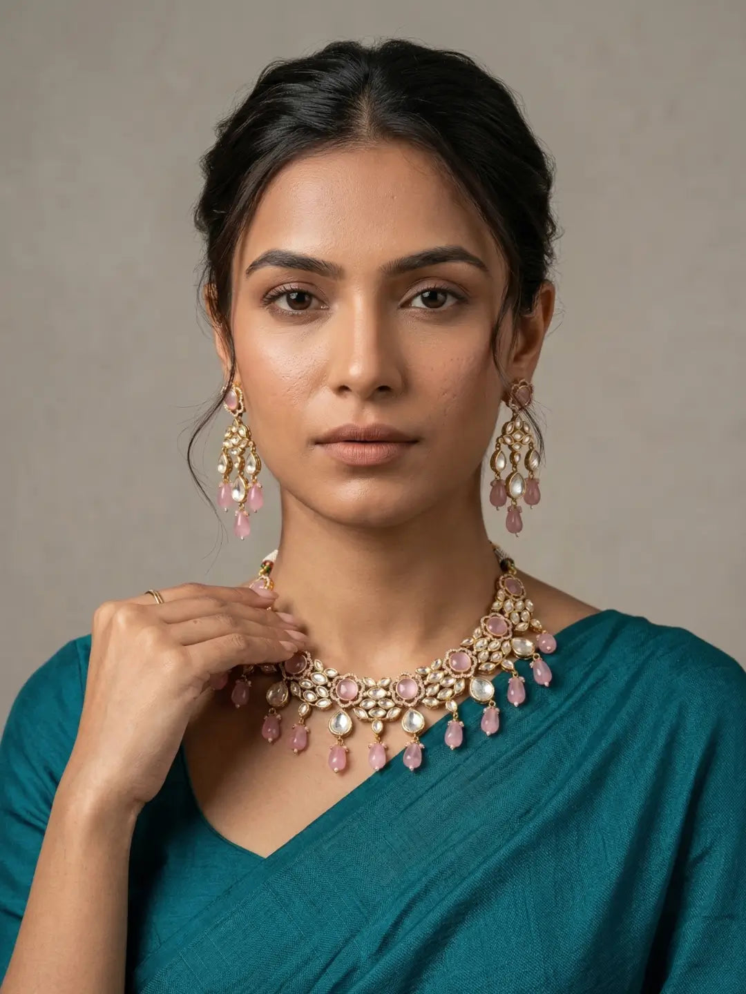 a women wearing an Elegant Pink Kundan necklace set with matching chandelier earrings featuring premium Kundan stones, Pink bead drops, and gold-tone finish, perfect for bridal wear, weddings, festive occasions, and traditional Indian jewellery.