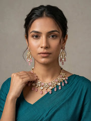 a women wearing an Elegant Pink Kundan necklace set with matching chandelier earrings featuring premium Kundan stones, Pink bead drops, and gold-tone finish, perfect for bridal wear, weddings, festive occasions, and traditional Indian jewellery.