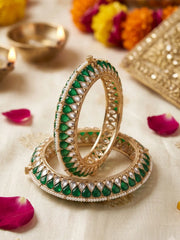 Handcrafted gold-plated Kundan bangles featuring sparkling Kundan stones, elegant pearl borders, and emerald green enamel detailing, perfect for bridal wear, weddings, festive occasions, and traditional Indian jewellery.