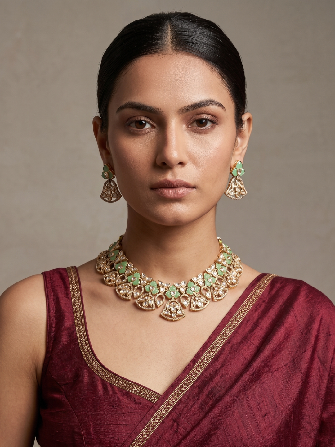 A women is wearing a handcrafted gold-plated floral Kundan necklace set with matching earrings featuring Polki, CZ stones and  mint green accents, ideal for bridal wear, weddings, festive occasions, and traditional Indian jewellery.