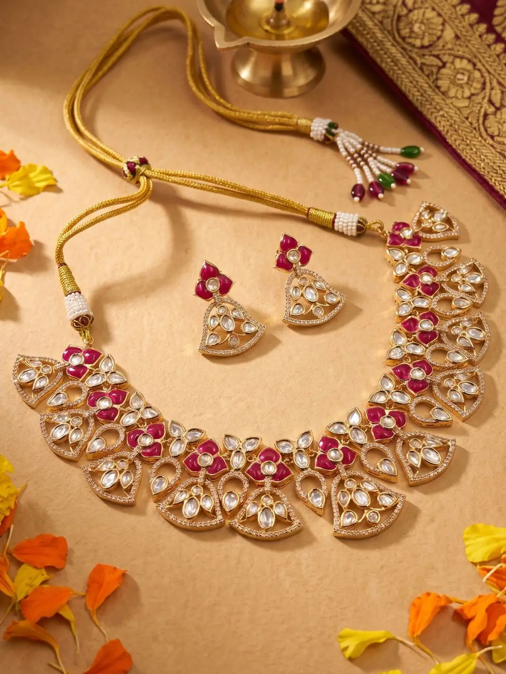 handcrafted gold-plated floral Kundan necklace set with matching earrings featuring Polki, CZ stones and  ruby red accents, ideal for bridal wear, weddings, festive occasions, and traditional Indian jewellery.