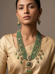 a women in a beige saree wearing a Handcrafted emerald green multi-layer beaded long necklace featuring an elegant Kundan pendant with matching earrings, perfect for bridal wear, weddings, festive celebrations, and traditional Indian jewellery.