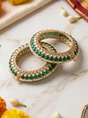 Handcrafted gold-plated Kundan bangles featuring sparkling Kundan stones, elegant pearl borders, and emerald green enamel detailing, perfect for bridal wear, weddings, festive occasions, and traditional Indian jewellery.