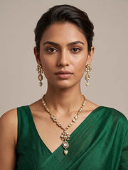 a women wearing an elegant gold-plated Kundan pendant necklace set with polki drop pendant and matching earrings, handcrafted traditional Indian jewellery for weddings, festive occasions, party wear, and ethnic outfits.