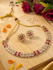 Kundna Jewelry set with necklace and earrings on a wooden surface with flowers in the background