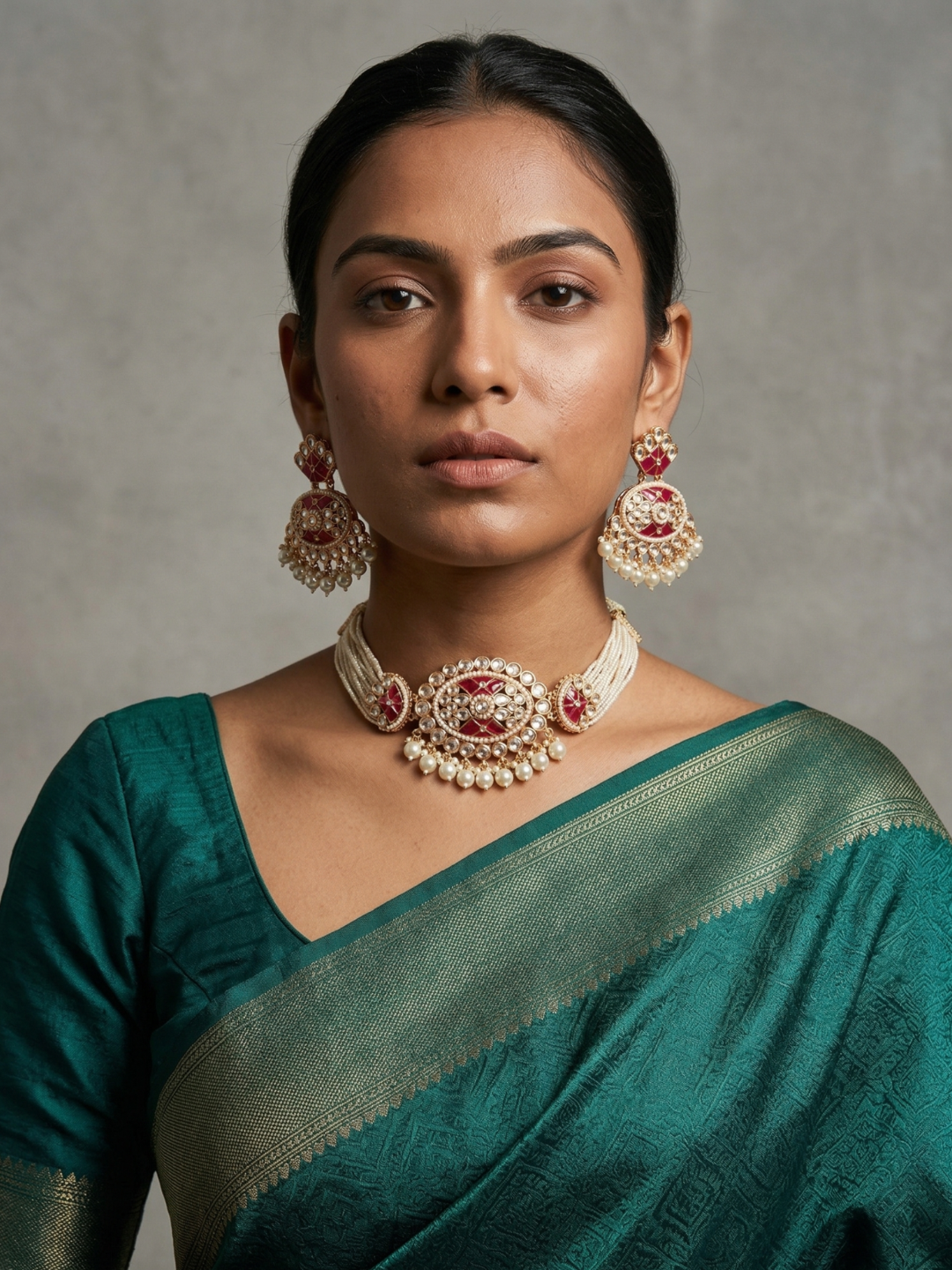 A women in a green saree is elegant multi-strand kundan and pearl choker necklace featuring a handcrafted Kundan centrepiece with pearl drop detailing and matching earrings, ideal for bridal wear, weddings, festive celebrations, and traditional Indian jewellery.wearing 