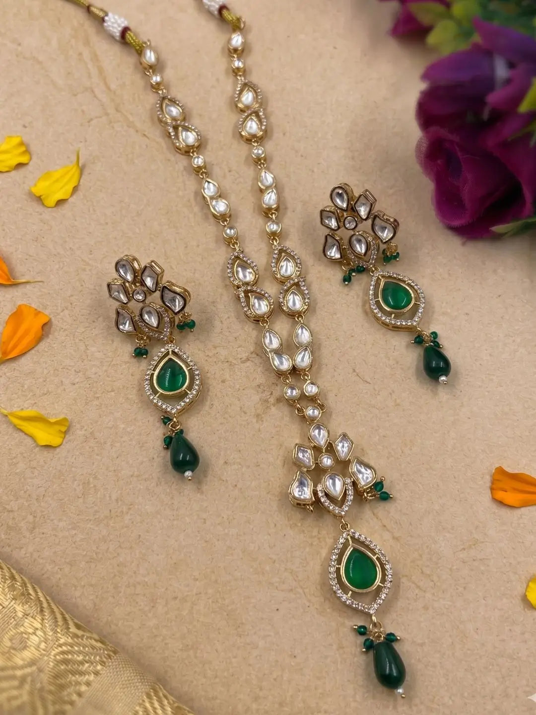 Elegant green gold-plated Kundan pendant necklace set with polki drop pendant and matching earrings, handcrafted traditional Indian jewellery for weddings, festive occasions, party wear, and ethnic outfits.