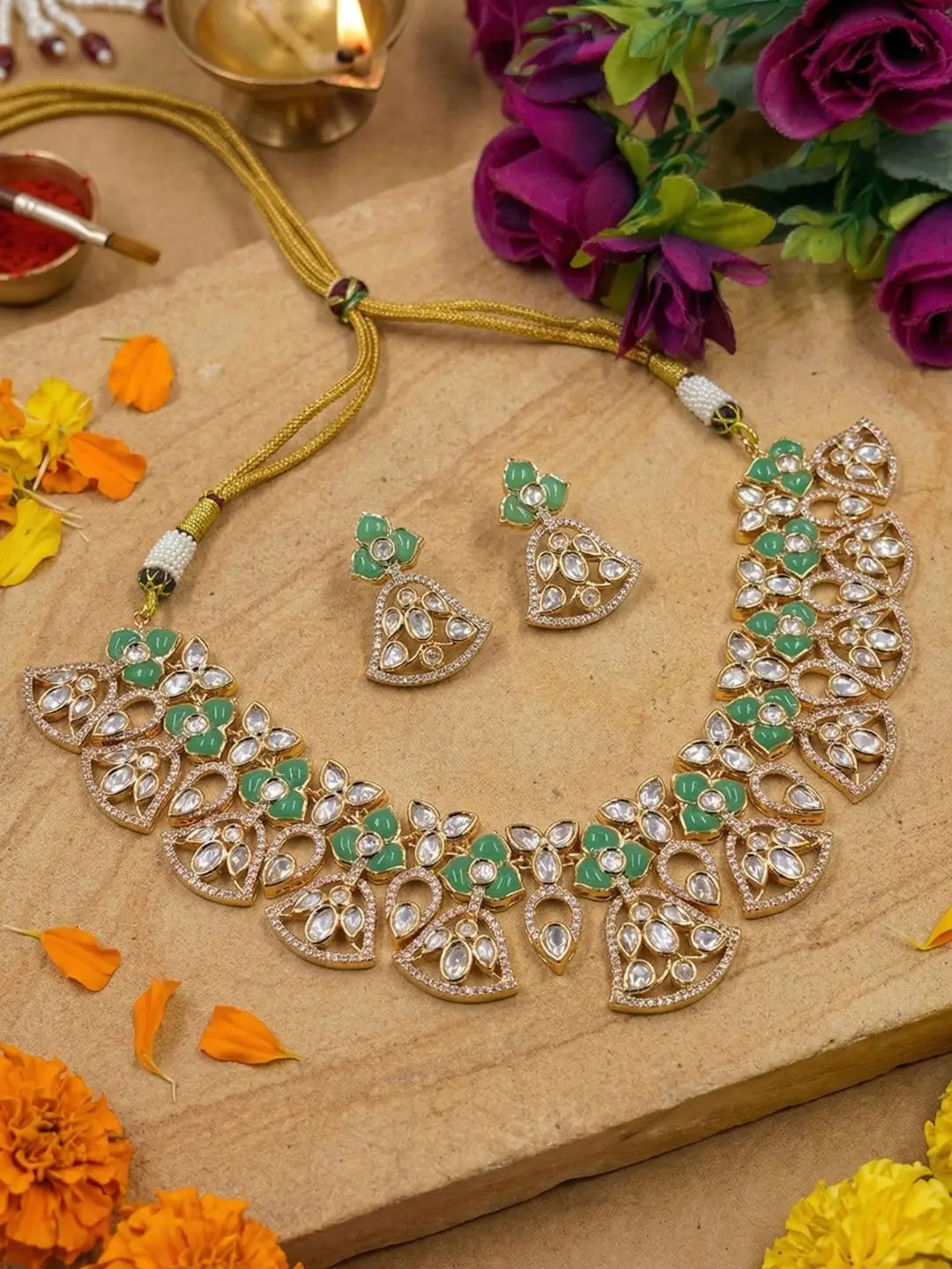 handcrafted gold-plated floral Kundan necklace set with matching earrings featuring Polki, CZ stones and  green accents, ideal for bridal wear, weddings, festive occasions, and traditional Indian jewellery.