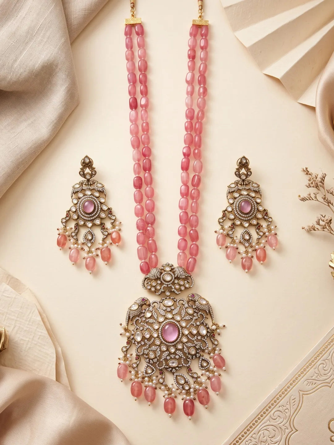 Traditional long antique moissanite polki necklace set with a big ornate pendant attached, rose pink layered beads, and matching long earrings for ethnic and saree wear 
