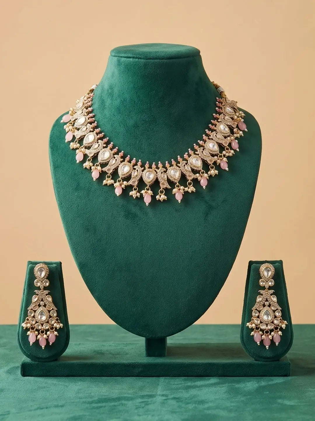 Jewelry set with necklace and earrings on a green mannequin against a beige background
