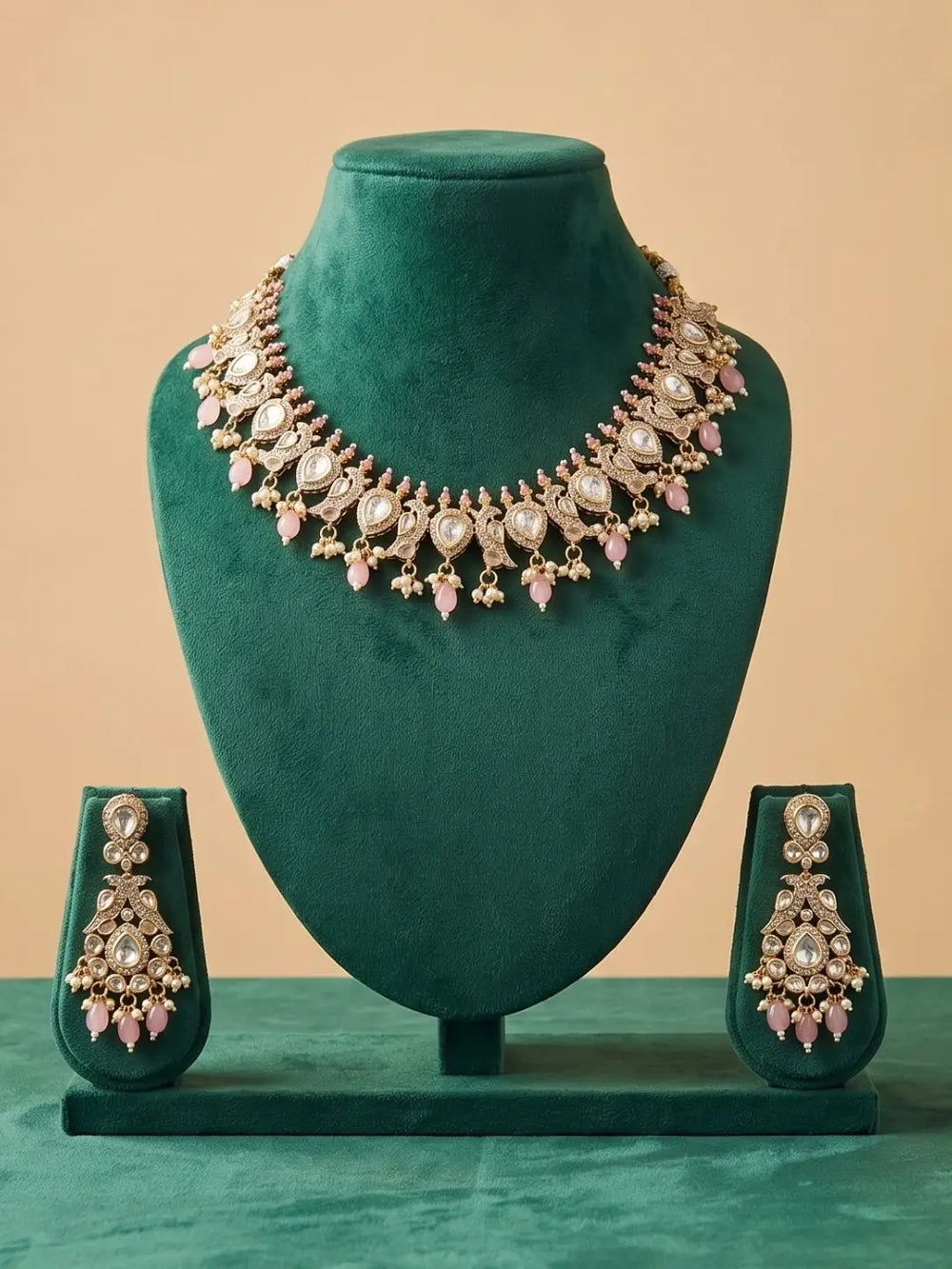 Jewelry set with necklace and earrings on a green mannequin against a beige background