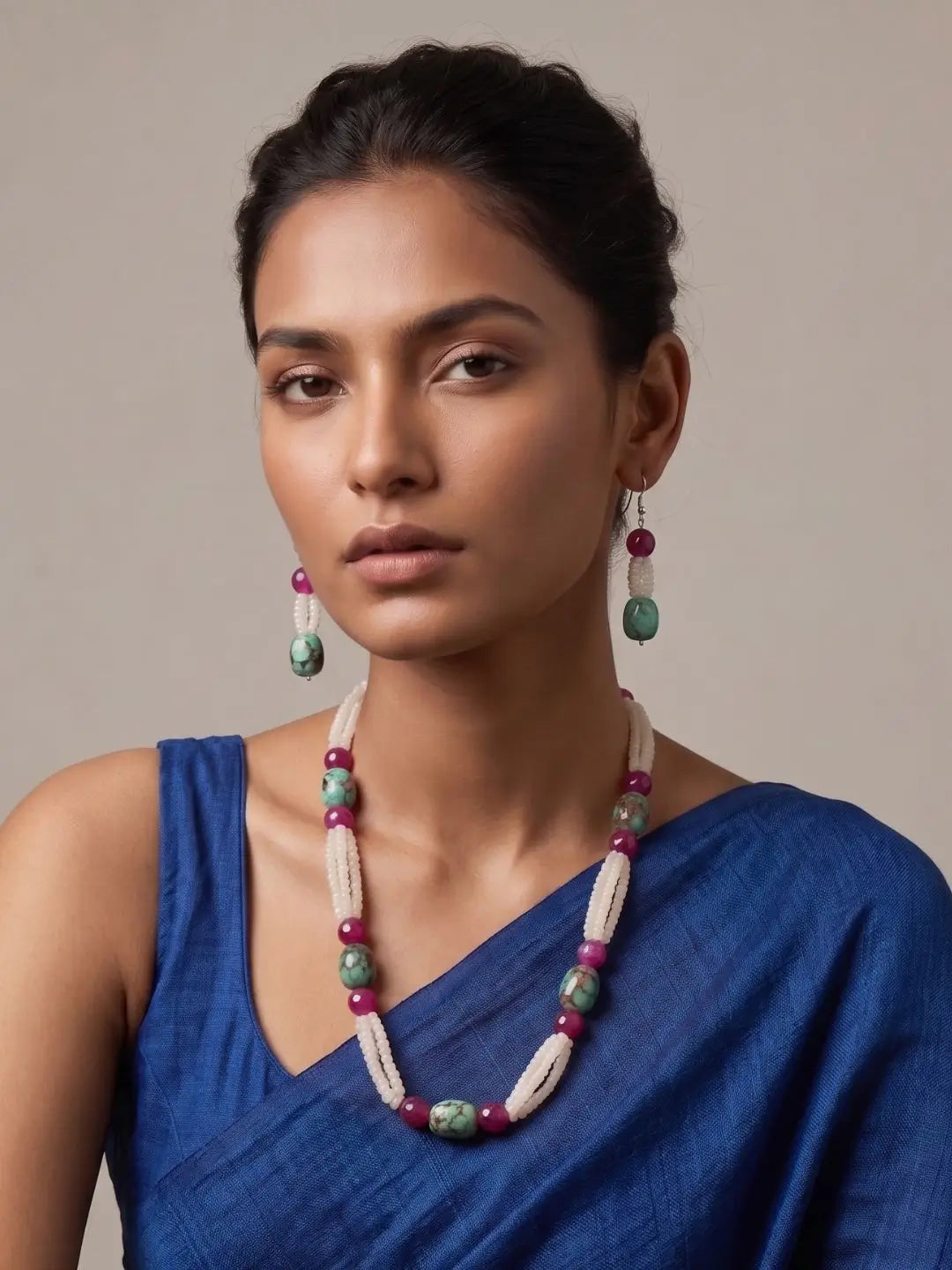 women wearing a White Rainbow Moonstone faceted beads necklace with natural Turquoise oval beads, Pink Onyx gemstones, and matching earrings on a aree