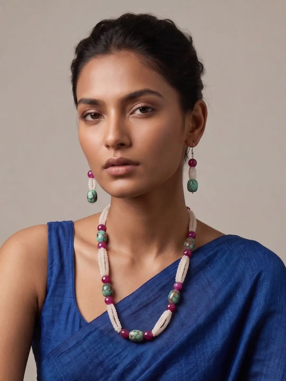 women wearing a White Rainbow Moonstone faceted beads necklace with natural Turquoise oval beads, Pink Onyx gemstones, and matching earrings on a aree