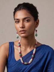women wearing a White Rainbow Moonstone faceted beads necklace with natural Turquoise oval beads, Pink Onyx gemstones, and matching earrings on a aree