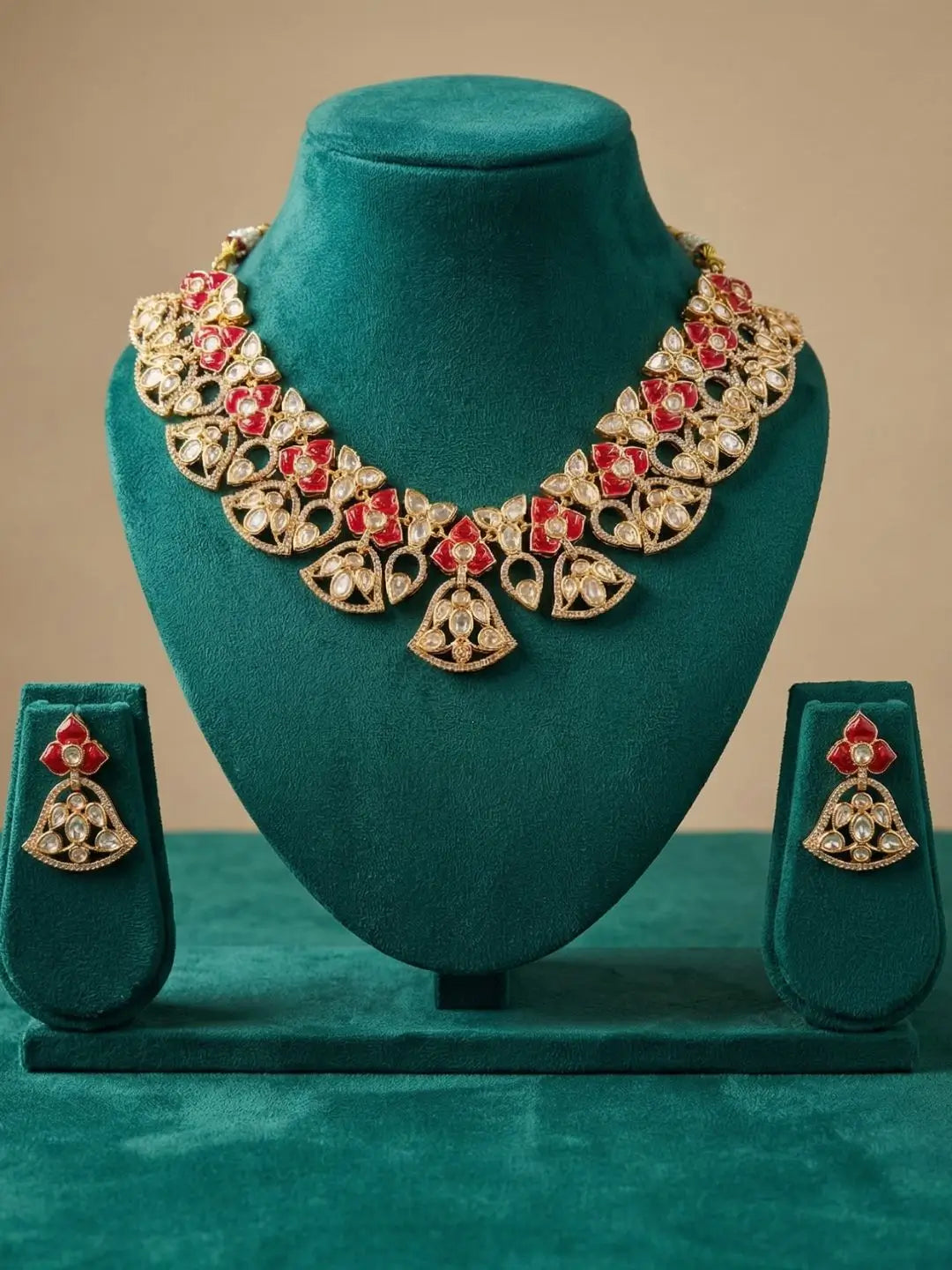 handcrafted gold-plated floral Kundan necklace set with matching earrings featuring Polki, CZ stones and  ruby red accents, ideal for bridal wear, weddings, festive occasions, and traditional Indian jewellery.