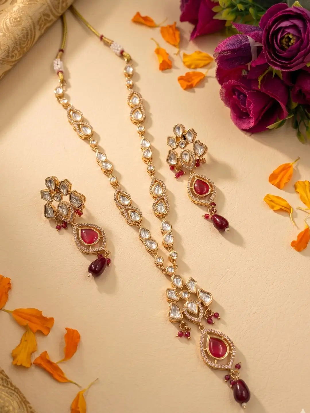 Elegant red gold-plated Kundan pendant necklace set with polki drop pendant and matching earrings, handcrafted traditional Indian jewellery for weddings, festive occasions, party wear, and ethnic outfits.