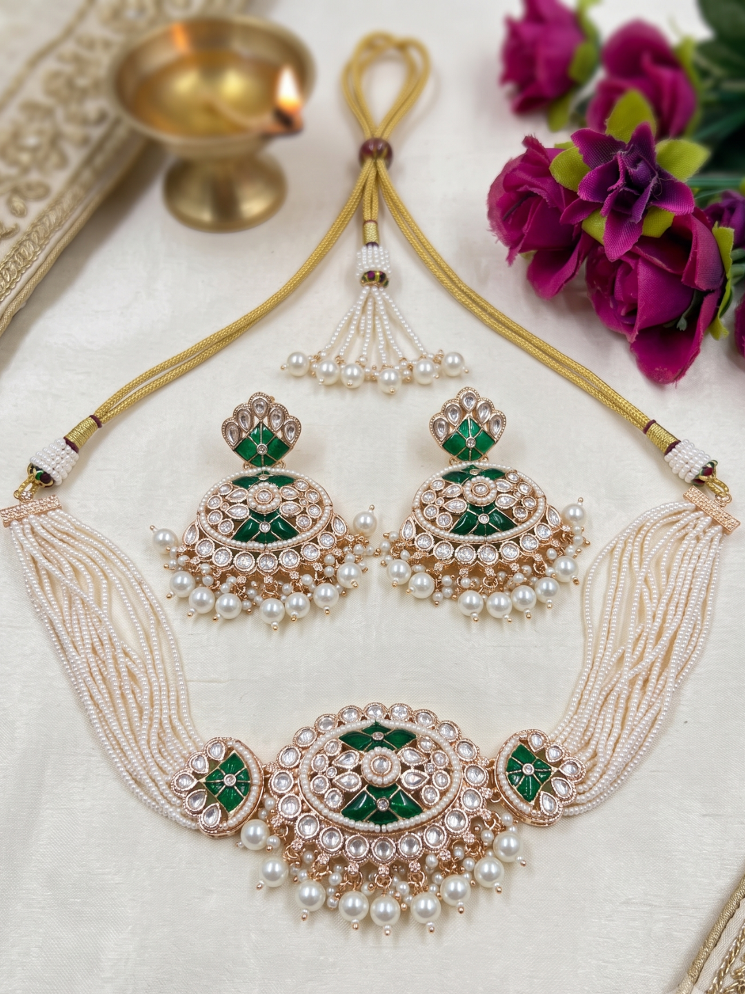 Elegant multi-strand green kundan and pearl choker necklace featuring a handcrafted Kundan centrepiece with pearl drop detailing and matching earrings, ideal for bridal wear, weddings, festive celebrations, and traditional Indian jewellery.