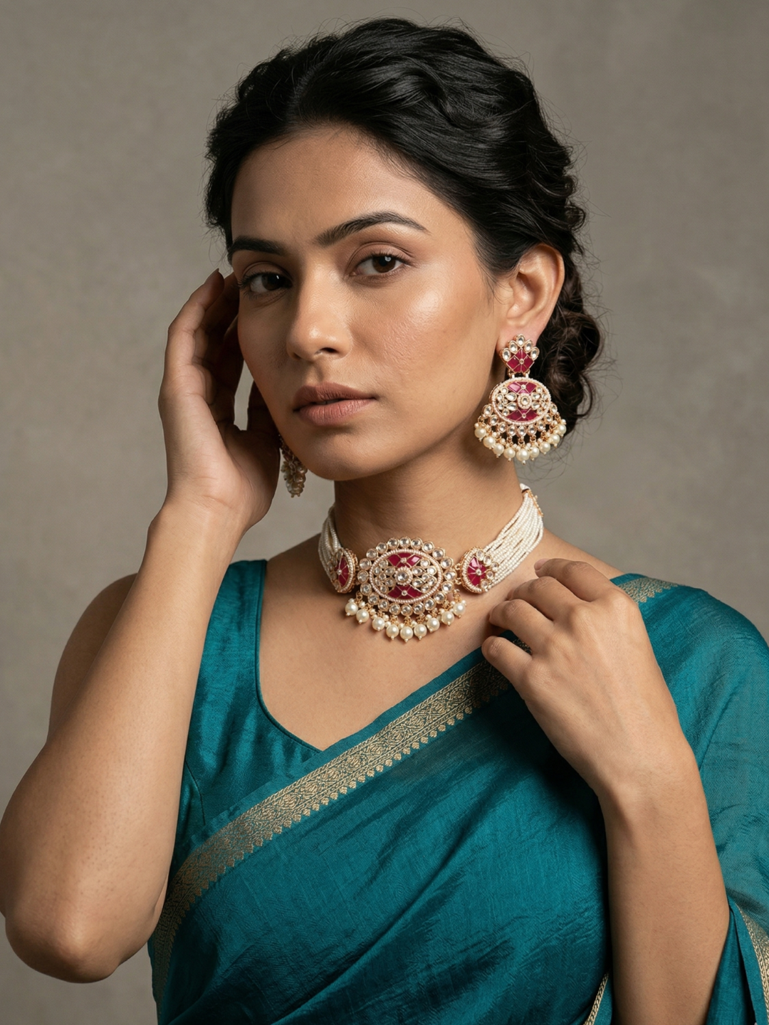a women wearing a blue saree with an Elegant multi-strand ruby red kundan and pearl choker necklace featuring a handcrafted Kundan centrepiece with pearl drop detailing and matching earrings, ideal for bridal wear, weddings, festive celebrations, and traditional Indian jewellery.